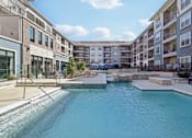 Thumbnail 19 of 49 - A swimming pool in a residential area surrounded by apartment buildings.