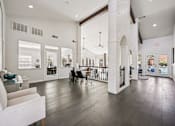 Thumbnail 19 of 45 - A white couch is in a room with a white column.