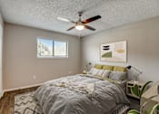 Thumbnail 15 of 42 - a bedroom with a large bed and a ceiling fan
