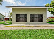 Thumbnail 29 of 33 - A small building with a grey roof and a black window with white lettering.