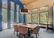 Thumbnail 22 of 50 - a dining room with a table and chairs and large windows