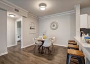 Thumbnail 9 of 48 - a dining room with a table and chairs