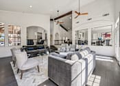 Thumbnail 21 of 45 - A modern living room with a grey sofa and a wooden floor.