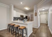 Thumbnail 7 of 48 - a kitchen with a breakfast bar and stools