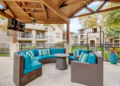 Thumbnail 33 of 44 - a covered patio with couches and a table