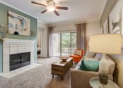 Thumbnail 1 of 44 - a living room with a fireplace and a ceiling fan