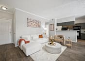 Thumbnail 9 of 45 - A living room with a white couch and a coffee table.