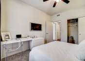 Thumbnail 11 of 42 - a bedroom with a large white bed and a white desk with a white chair