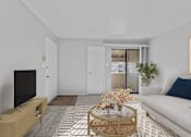 Thumbnail 9 of 37 - a living room with a white couch and a coffee table