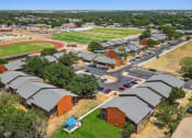 Thumbnail 14 of 19 - an aerial view of a city with a baseball field in the background