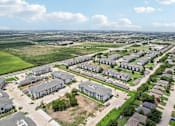 Thumbnail 66 of 70 - A bird's eye view of a residential area with houses and apartment buildings.