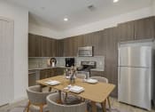 Thumbnail 3 of 37 - a kitchen with stainless steel appliances and a wooden table