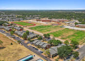 Thumbnail 15 of 19 - arial view of the campus with the football field and soccer field in the foreground