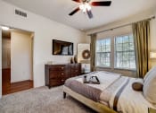 Thumbnail 10 of 42 - the master bedroom features a king sized bed and a flat screen tv