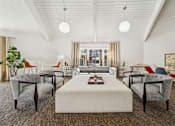 Thumbnail 13 of 35 - A room with a white table and chairs with a carpet on the floor.