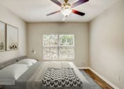 Thumbnail 9 of 34 - a bedroom with a large bed and a ceiling fan