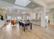 Thumbnail 22 of 44 - a dining room with a table and chairs in the center
