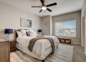 Thumbnail 10 of 48 - a bedroom with a bed and a ceiling fan