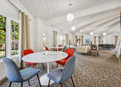 Thumbnail 15 of 35 - A white round table with four chairs around it in a room with a white ceiling.