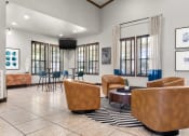 Thumbnail 22 of 28 - a resident clubhouse with couches chairs and a coffee table