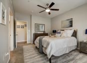 Thumbnail 12 of 48 - a bedroom with a bed and a ceiling fan