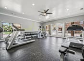 Thumbnail 25 of 45 - A spacious home gym with a treadmill, weights, and exercise equipment.