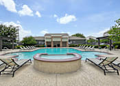 Thumbnail 20 of 32 - A pool with lounge chairs around it.