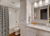 Thumbnail 8 of 11 - a bathroom with a shower toilet and sink and a mirror