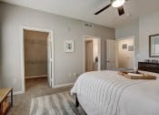 Thumbnail 13 of 48 - a bedroom with a large bed and a ceiling fan
