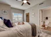 Thumbnail 11 of 48 - a bedroom with a bed and a ceiling fan