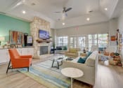 Thumbnail 21 of 44 - a living room with couches and chairs and a fireplace