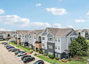 Thumbnail 36 of 70 - A row of townhouses with a parking lot in front.