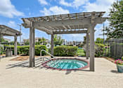 Thumbnail 21 of 32 - A pool under a pergola in a sunny backyard.
