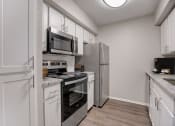 Thumbnail 4 of 11 - a kitchen with stainless steel appliances and white cabinets
