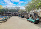Thumbnail 43 of 50 - a resort style swimming pool with lounge chairs and a hotel in the background