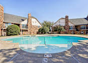 Thumbnail 25 of 35 - A swimming pool surrounded by a brick building.
