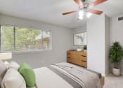 Thumbnail 6 of 23 - a bedroom with a bed and a ceiling fan