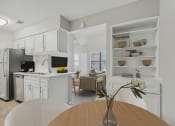 Thumbnail 3 of 28 - a kitchen and dining room with white cabinets and appliances and a wooden table