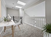 Thumbnail 5 of 15 - a home office with a white desk and a balcony