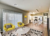 Thumbnail 1 of 33 - a living room and kitchen with yellow chairs and a table