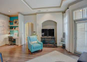 Thumbnail 15 of 52 - a living room with a fireplace and a blue chair