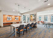 Thumbnail 31 of 49 - A conference room with a long table and chairs.