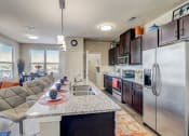 Thumbnail 4 of 50 - a kitchen with stainless steel appliances and a granite counter top