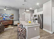 Thumbnail 3 of 36 - A kitchen with a zebra print bench in front of a counter.