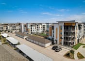 Thumbnail 41 of 44 - an aerial view of an apartment complex with cars parked in front of it