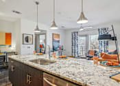 Thumbnail 6 of 49 - A kitchen with a marble countertop and modern appliances.
