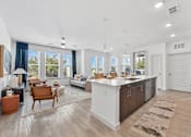 Thumbnail 4 of 54 - A modern kitchen with a white island and wooden floors.