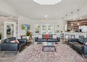 Thumbnail 40 of 70 - A living room with a large rug and a coffee table in the middle.