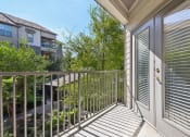 Thumbnail 11 of 28 - the view from the balcony of a home with a door to the yard