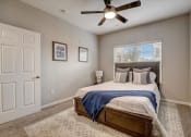 Thumbnail 16 of 48 - a bedroom with a large bed and a ceiling fan